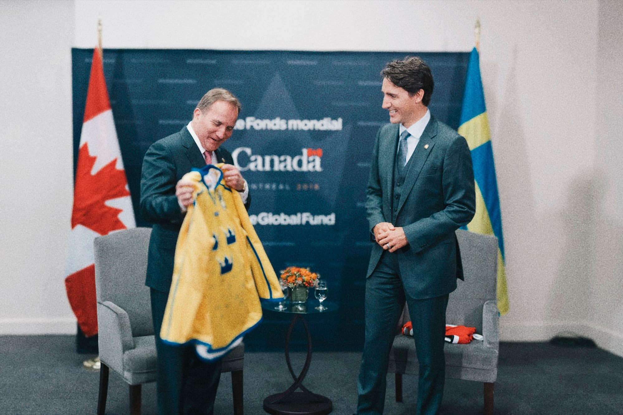 Two leaders holding up a Swedish football shirt